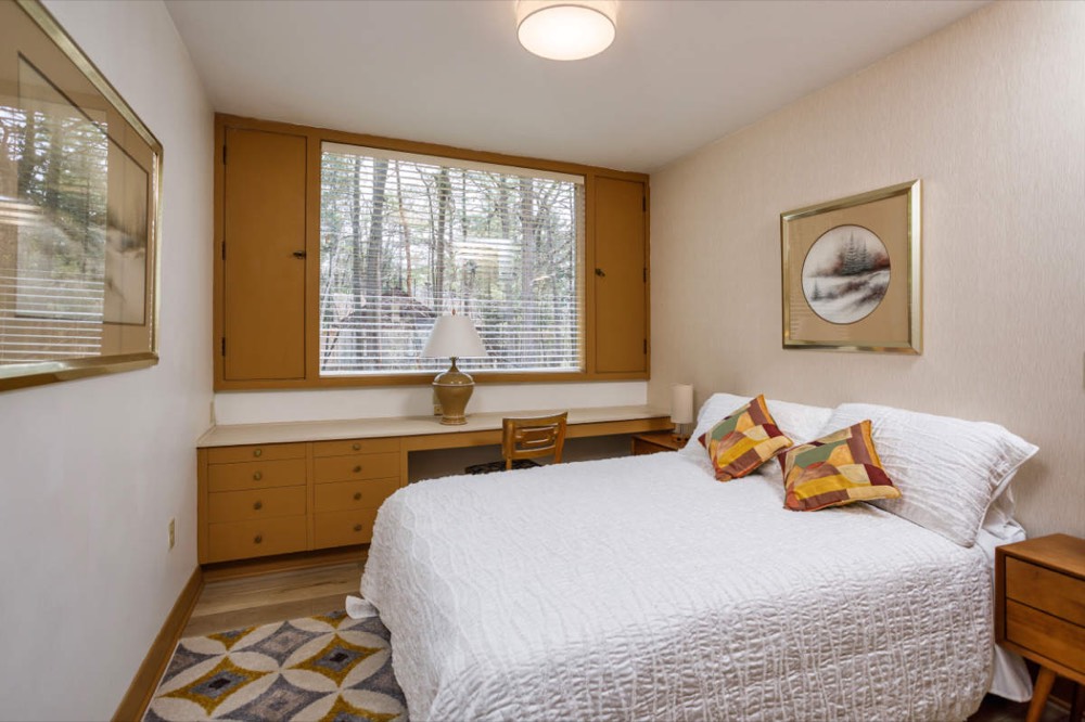 Second bedroom with a queen bed and built-in desk