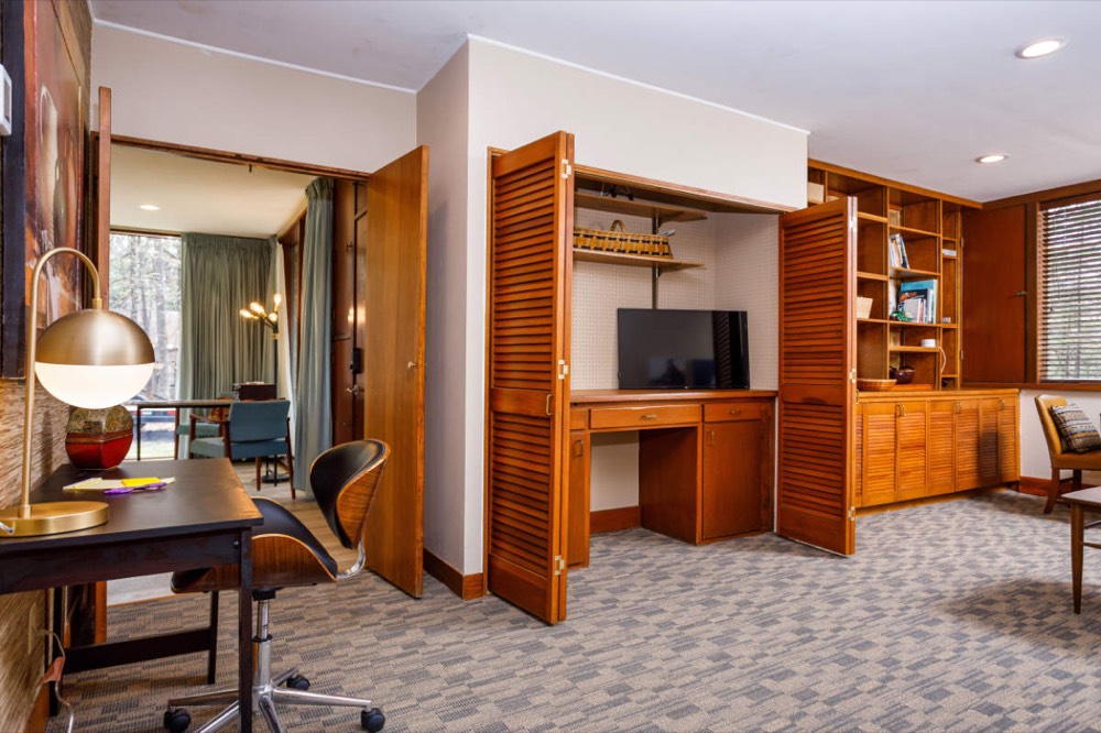 Den with built-in bookshelves used as an office and library