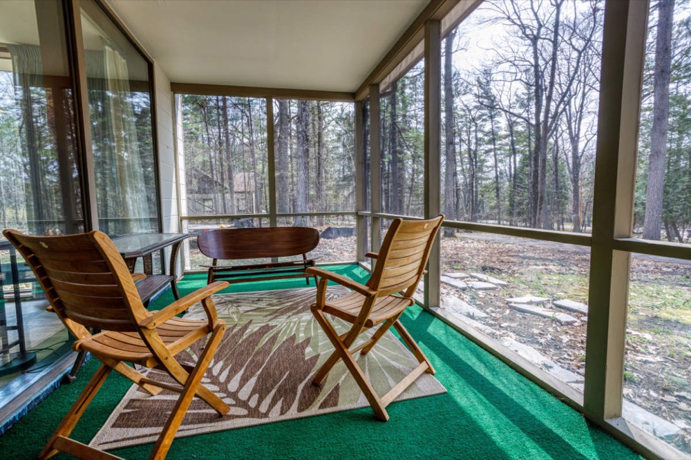 Screened porch furnished as an extra room